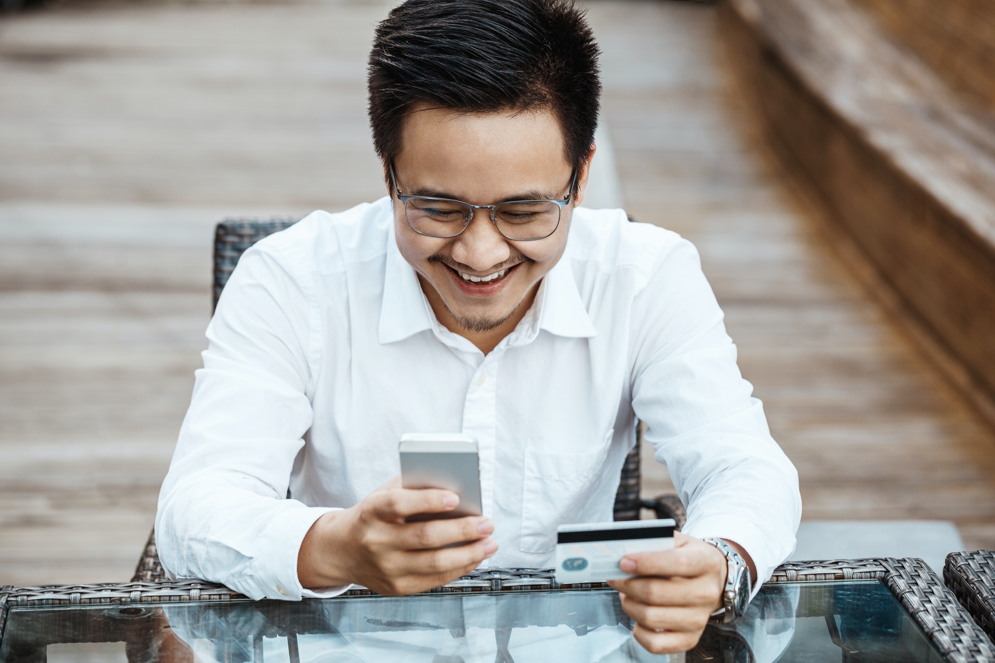young handsome man enjoy shopping online on mobile phone with credit card